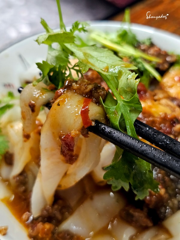 栗園米食-國宴粄條-泰式酸辣打拋豬粄條-滿滿香菜與豬血糕甜不辣-夾起粄條